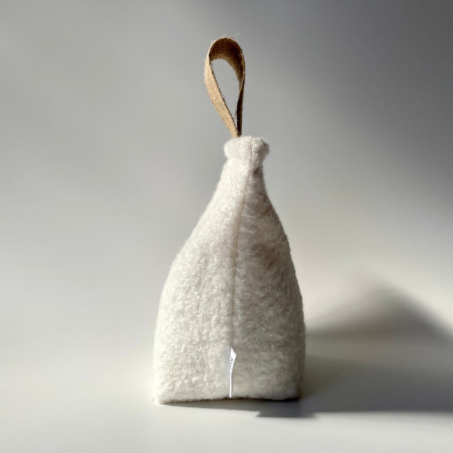 Boucle Fabric Doorstop shown side on.