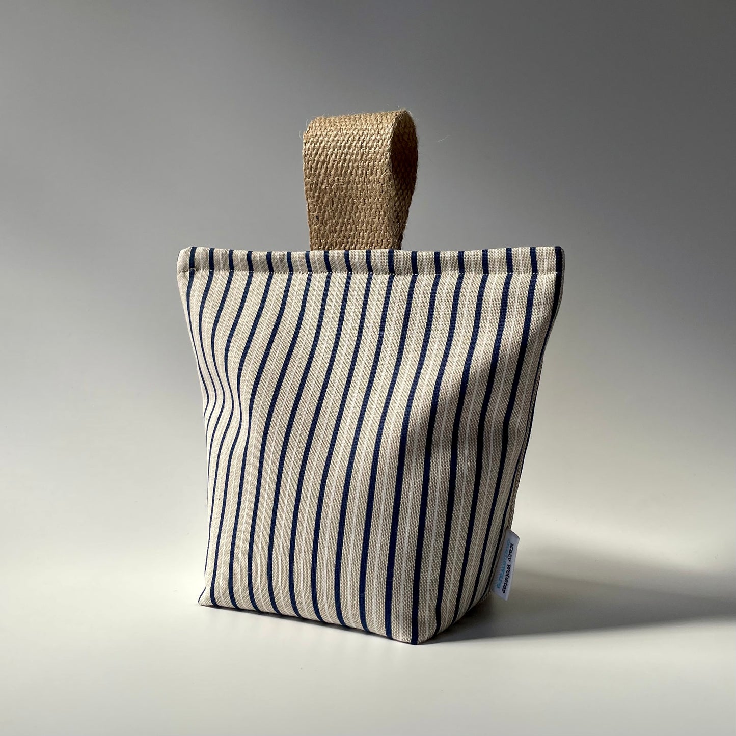 Blue and white stripe on natural background fabric doorstopper with jute handle.