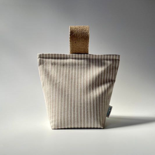 Fabric doorstop with a beige and white vertical pinstripe pattern, featuring a thick jute handle on top.
