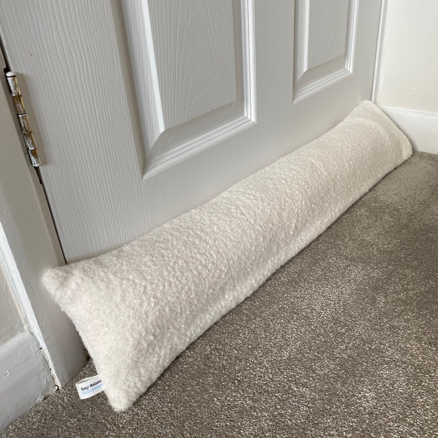 Ivory Boucle Weighted Draught Excluder with washable cover.