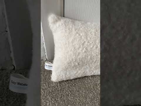 Ivory Boucle Weighted Draught Excluder with washable cover.