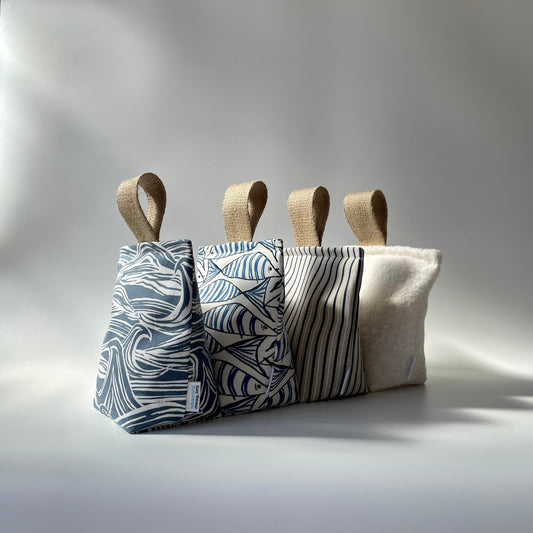 Range of nautical and coastal fabric doorstops including wave, fish, stripe and boucle fabric options.