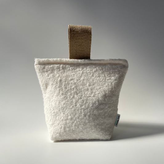 Heavy white boucle filled doorstop with jute handle.