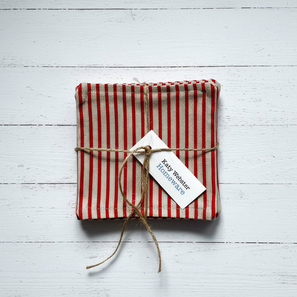 Red and beige striped fabric coasters tied with twine.