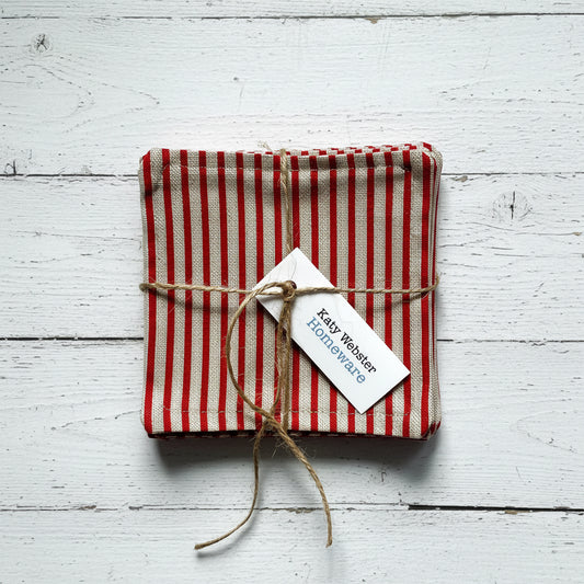 Red and beige striped fabric coasters tied with twine.