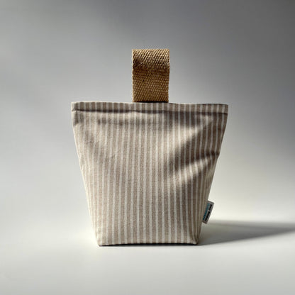 Fabric doorstop with a beige and white vertical pinstripe pattern, featuring a thick jute handle on top.