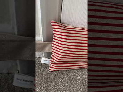 Red and beige stripe weighted draught excluder with washable cover and matching beige hanging loop.