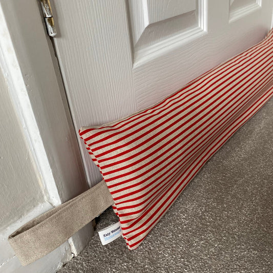 Red and beige stripe weighted draught excluder with washable cover and matching beige hanging loop.