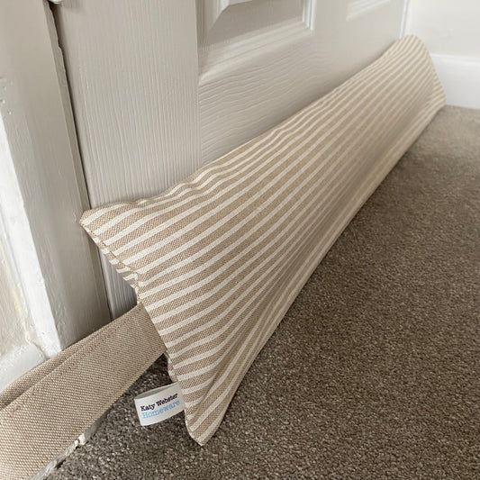Heavy draught excluder with washable beige and white stripe cover and hanging loop.